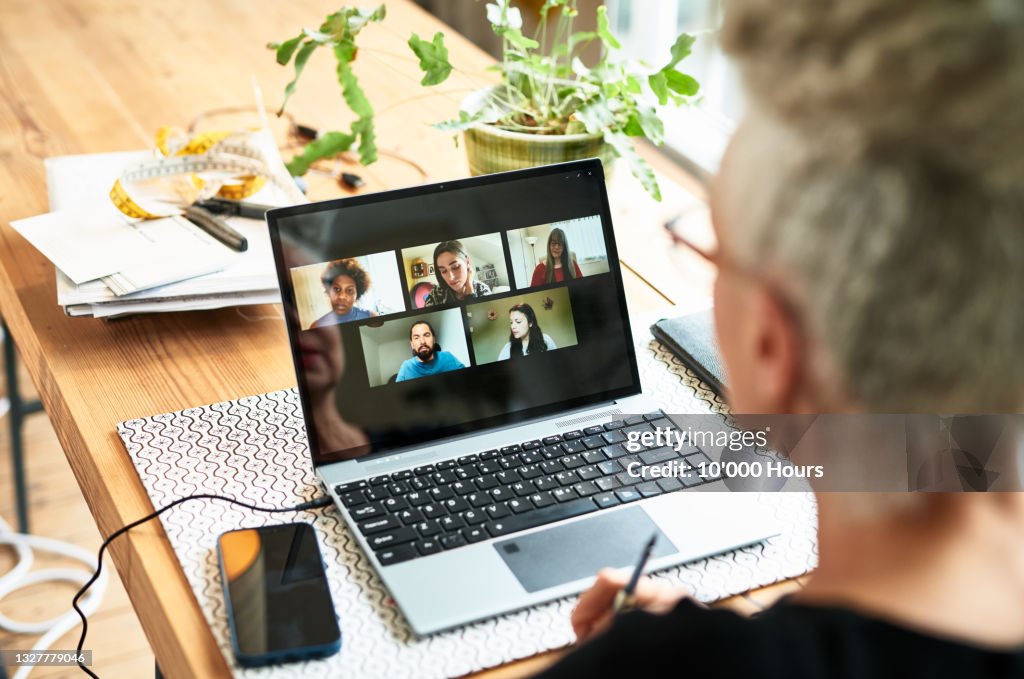 Senior businesswoman using laptop for team meeting video conference