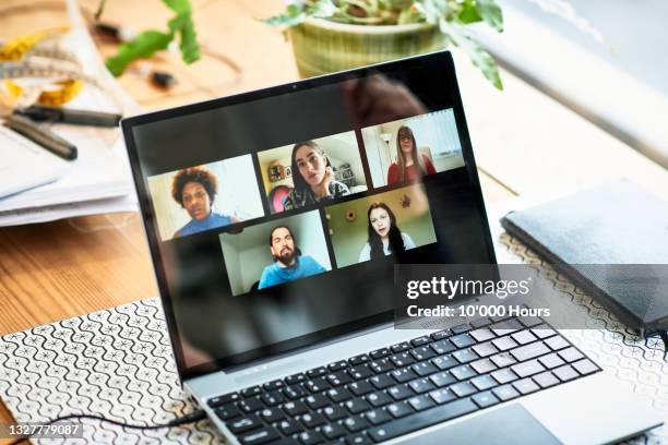 five faces on laptop screen during video conference - videokonferenz stock-fotos und bilder