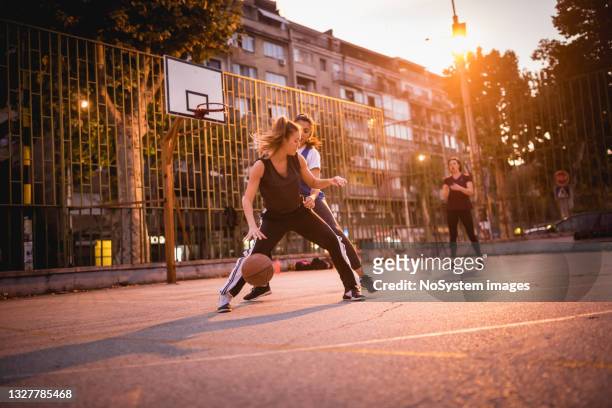 girlfriends playing basketball - street basketball stockfoto's en -beelden