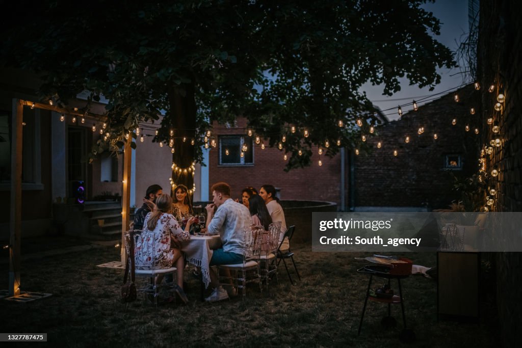 Friends on dinner party in back yard