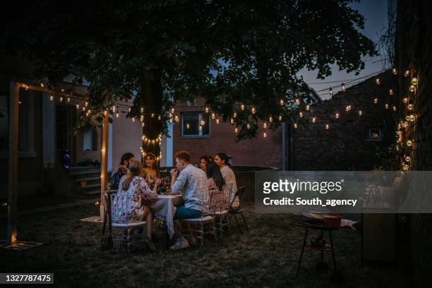 friends on dinner party in back yard - garden lighting bildbanksfoton och bilder