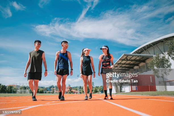 asian chinese confidence proud athlete sport team walking talking on all-weather-track and field stadium in the morning - forward athlete stock pictures, royalty-free photos & images