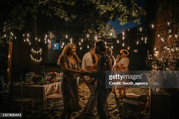 people on party in back yard - garden party stock pictures, royalty-free photos & images