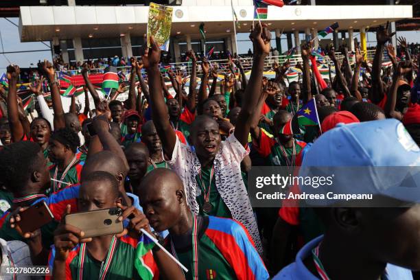 People who ran in The Great South Sudan Run are waving flags at John Garang Mausoleum, during the country's 10th anniversary since independence, on...