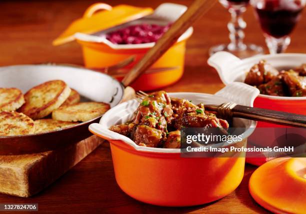 wild boar goulash with red cabbage and napkin dumplings - ragout stock pictures, royalty-free photos & images