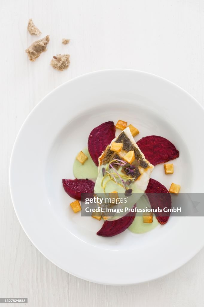 Branzini on roasted beetroot with wasabi sauce and celery croutons