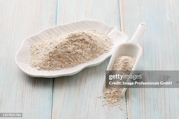 oat bran on a plate and on a scoop - bran stock pictures, royalty-free photos & images