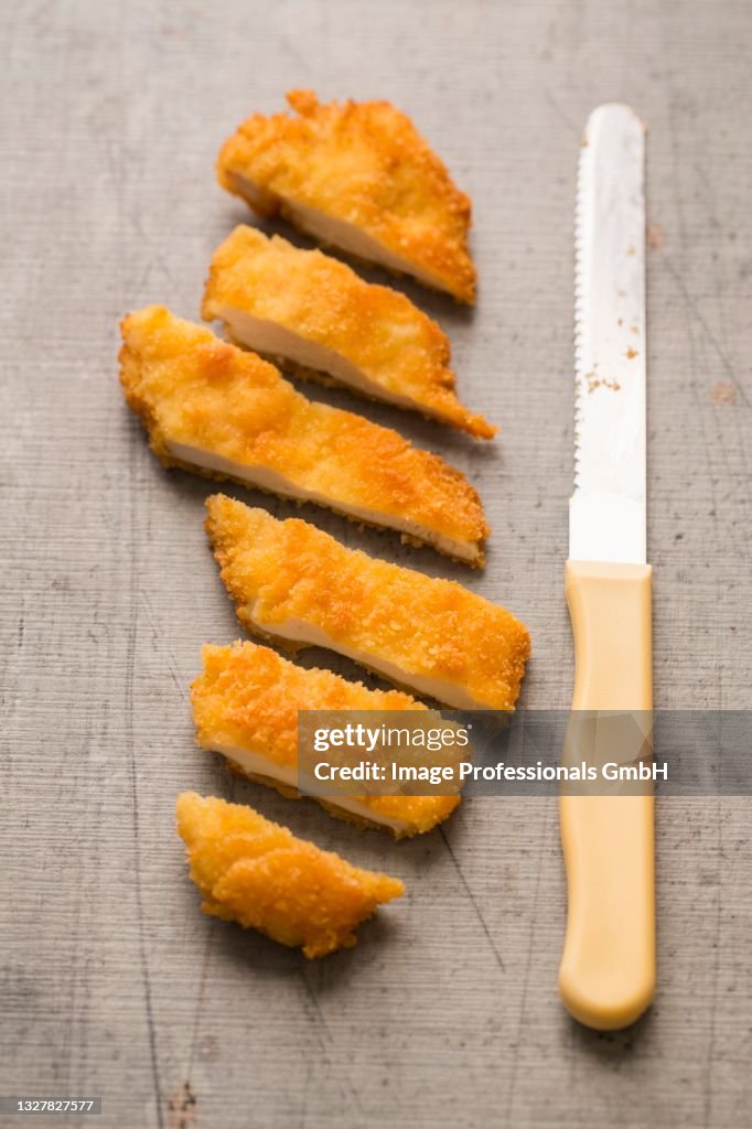 Gluten-free chicken escalope in breadcrumbs, cut into slices