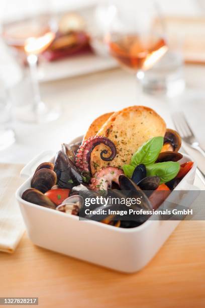 mussel soup with squid and croutons (italy) - pulpo stock pictures, royalty-free photos & images