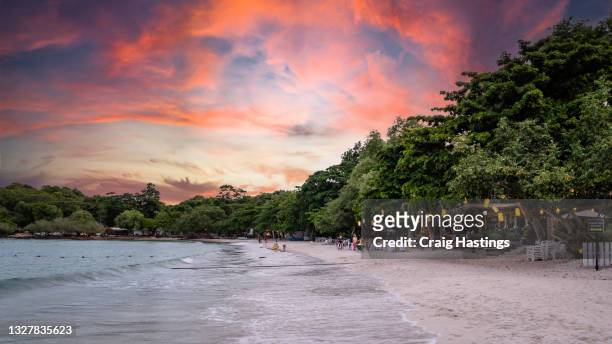beautiful thai island beach at sunset with romantic dramatic sky and clouds on koh samet, thailand - tropical sunsets stock pictures, royalty-free photos & images