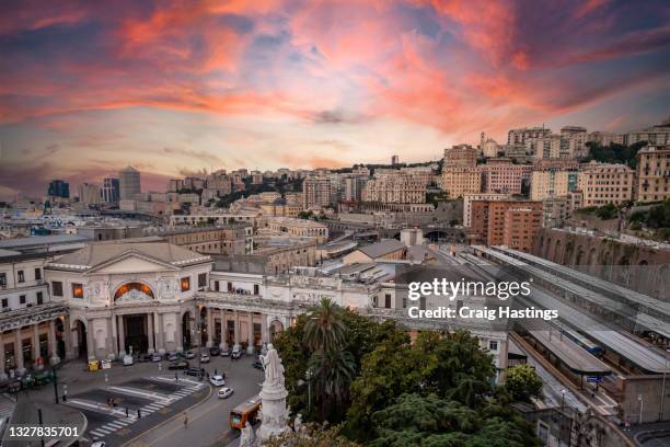 dramatic amazing italian train station and urban cityscape skyline scene at sunset in genoa, italy - genoa stock-fotos und bilder