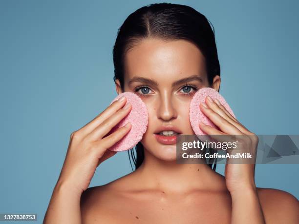 young woman cleans the skin natural sponge - pore stock pictures, royalty-free photos & images