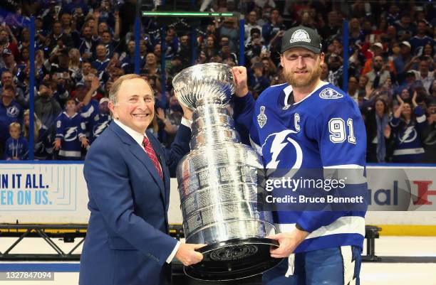 NHlL Commissioner Gary Bettman presents Steven Stamkos of the Tampa Bay Lightning with the Stanley Cup following the victory over the Montreal...