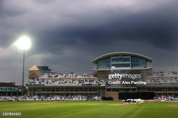 General view of grey skies as the rain covers a brought onto the wicket during the Vitality T20 Blast match between Notts Outlaws and Yorkshire...