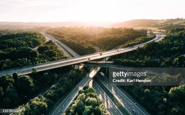 an aerial sunset view of a uk motorway - stock photo - straßenüberführung stock-fotos und bilder