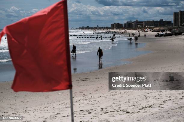 Surfers take advantage of unusually high surf due to Tropical Storm Elsa at Rockaway Beach in Queens on July 09, 2021 in New York City. After coming...