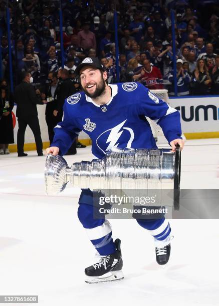 Tyler Johnson of the Tampa Bay Lightning celebrates with the Stanley Cup following the victory over the Montreal Canadiens in Game Five of the 2021...