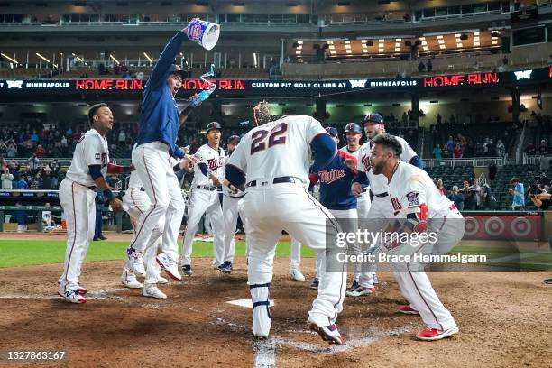 Miguel Sano of the Minnesota Twins celebrates with teammates after hitting a walk-off home run against the Cincinnati Reds on June 21, 2021 at Target...