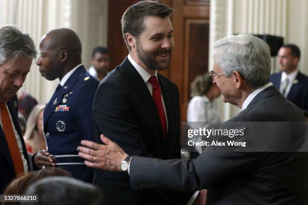 Attorney General Merrick Garland greets National Economic Council Director Brian Deese prior to an event at the State Dining Room of the White House...