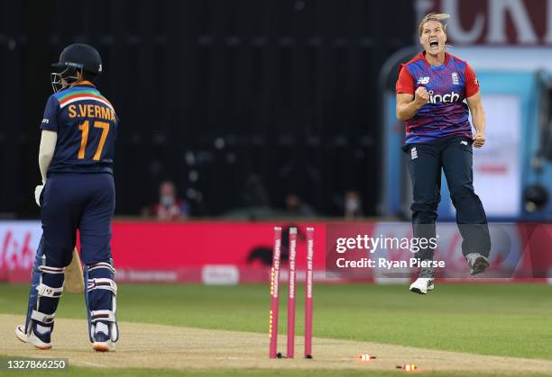 Katherine Brunt of England celebrates after taking the wicket of Shafali Verma of India during the Women's First T20 International between England...