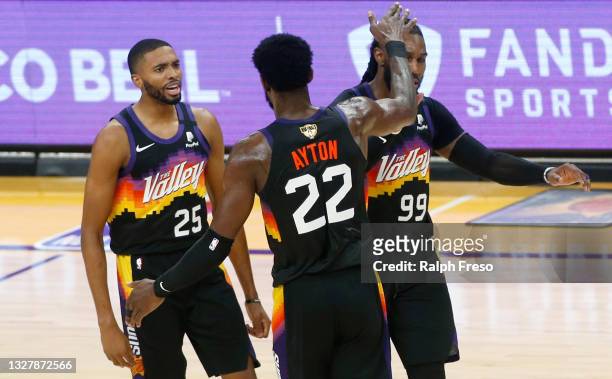 Deandre Ayton of the Phoenix Suns is congratulated by Mikal Bridges and Jae Crowder of the Suns during a first half timeout in Game Two of the NBA...