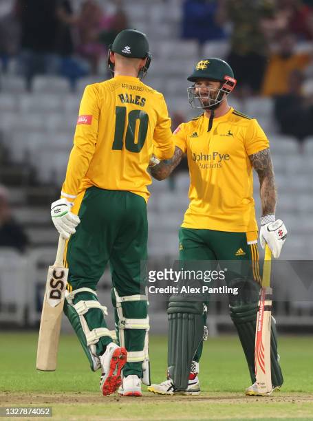 Notts openers Peter Trego and Alex Hales celebrate runs during the Vitality T20 Blast match between Notts Outlaws and Yorkshire Vikings at Trent...
