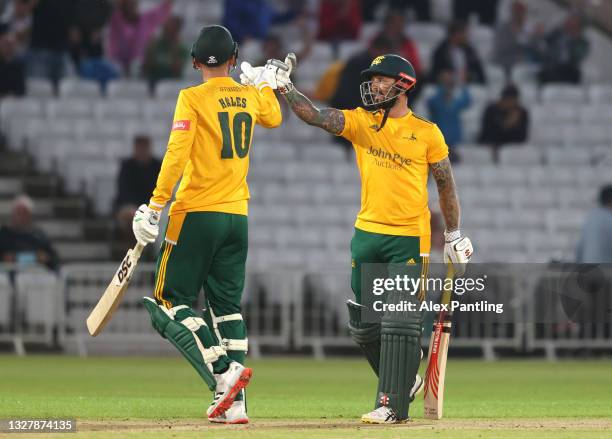 Notts openers Peter Trego and Alex Hales celebrate runs during the Vitality T20 Blast match between Notts Outlaws and Yorkshire Vikings at Trent...