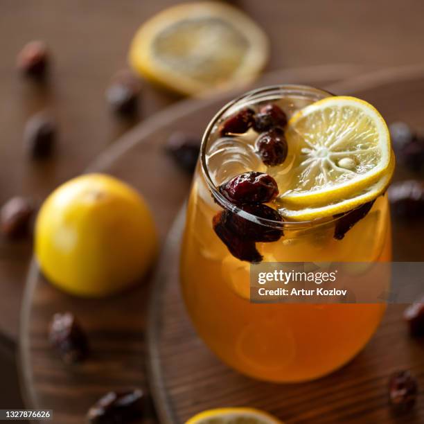 refreshing healthy drink on wooden table. orange citrus beverage. glass of lemonade. close-up shot. soft focus - soft drink stock-fotos und bilder