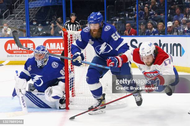 Josh Anderson of the Montreal Canadiens skates against Andrei Vasilevskiy and David Savard of the Tampa Bay Lightning in Game Five of the 2021 NHL...