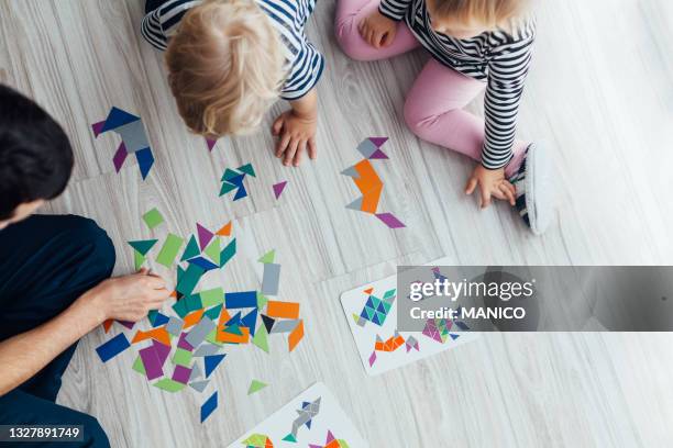 father playing with children - three storey stock pictures, royalty-free photos & images