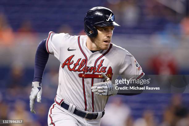Freddie Freeman of the Atlanta Braves watches his solo home run during the first inning off Anthony Bass of the Miami Marlins at loanDepot park on...