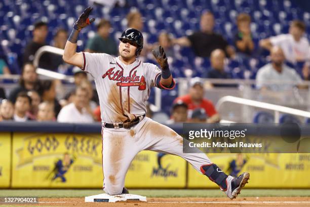 Austin Riley of the Atlanta Braves celebrates after hitting a RBI triple during the seventh inning against the Miami Marlins at loanDepot park on...