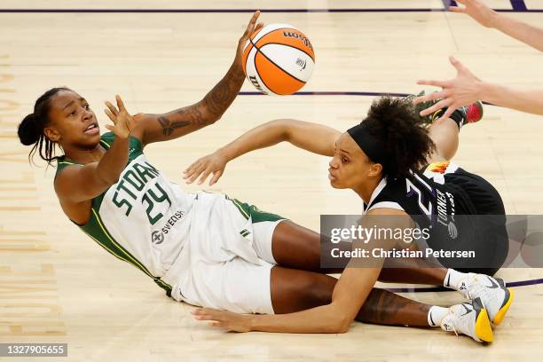 Jewell Loyd of the Seattle Storm passes the ball pressured by Brianna Turner of the Phoenix Mercury during the first half of the WNBA game at Phoenix...