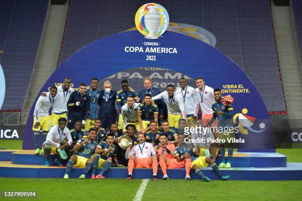 Juan Cuadrado and David Ospina of Colombia pose with the third place trophy after winning a Third Place play off match between Peru and Colombia as...