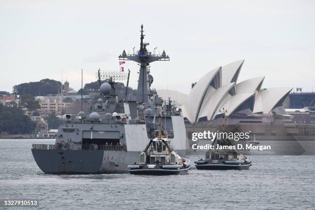 Crew members from the ROKS Wang Geon, a Chungmugong Yi Sun-sin-class destroyer in the Republic of Korea Navy, wave to people on the shore as she...