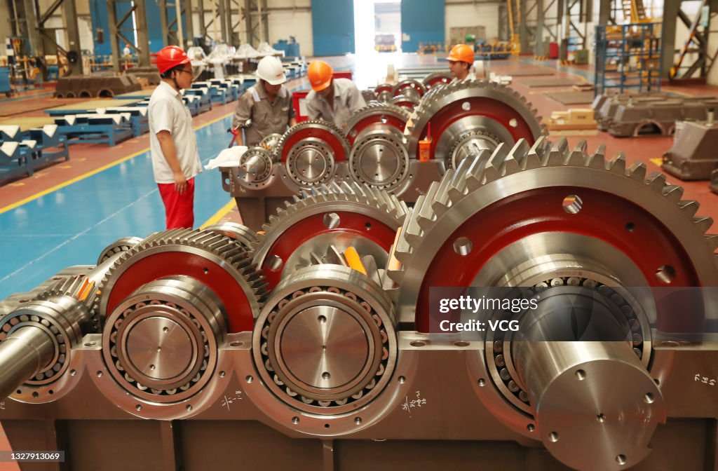 Reducer Manufacturing Employee work on the assembly line of reduction gear box at a factory ...