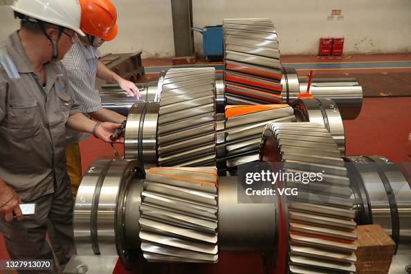 Reducer Manufacturing Employee work on the assembly line of reduction gear box at a factory ...