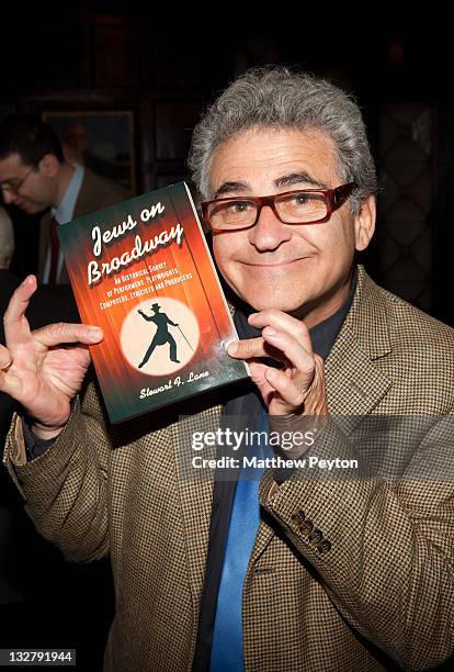 Actor Paul Kreppel poses with a book at the Book Signing for Stewart F. Lane's "Jews on Broadway" at New York Friars Club on May 11, 2011 in New York...
