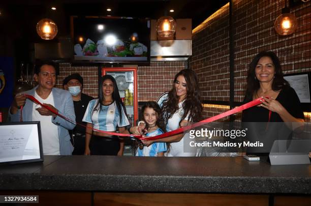 Dorismar and her family cut the ribbon during during the presentation of the first single for Caín Guzmán at Hipodromo Condesa on July 9, 2021 in...