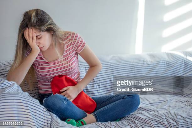 woman got stomachache using hot water - pms stock pictures, royalty-free photos & images