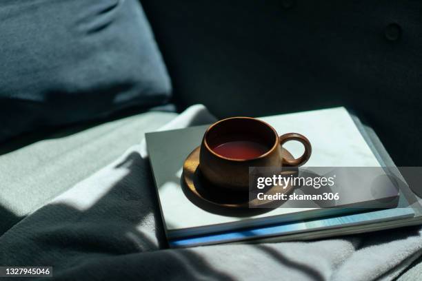 close up wooden coffee cup on cozy sofa bed - plateau en bois photos et images de collection
