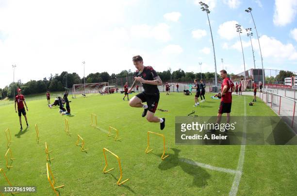 Adrian Fein of FC Bayern Muenchen practices as team coach Julian Nagelsmann watches him during a training session at the club's Saebener Strasse...