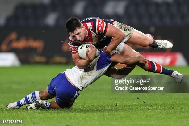 Victor Radley of the Roosters is tackled during the round 17 NRL match between the Canterbury Bulldogs and the Sydney Roosters at Bankwest Stadium,...