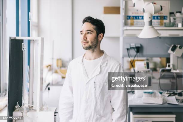positive scientist in workplace - scientist in lab coat stock pictures, royalty-free photos & images