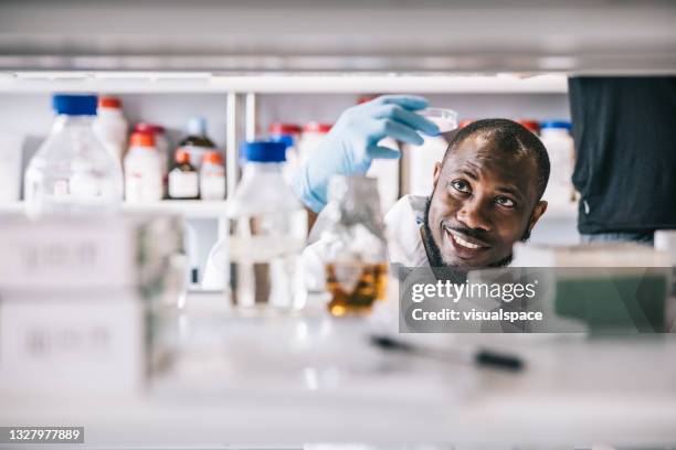 positive scientist making a new discovery - scientist stock pictures, royalty-free photos & images