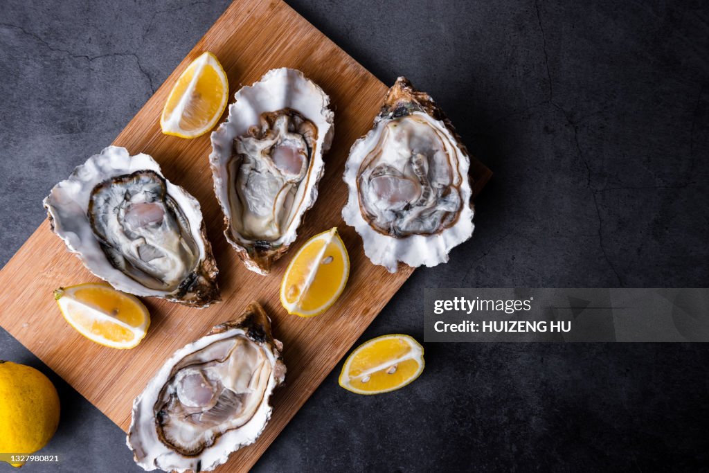Opened Oysters on table with lemon