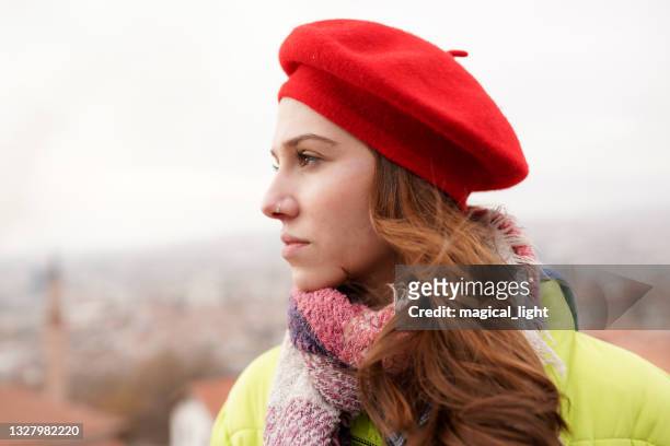 outdoor close up portrait of young beautiful blonde woman posing on street of european city - beret cap stock pictures, royalty-free photos & images