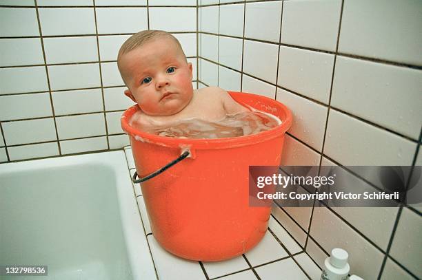 baby in bucket - vlieland stock pictures, royalty-free photos & images