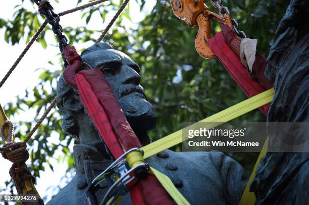 Workers remove a statue of Confederate General Thomas "Stonewall" Jackson from the Charlottesville and Albemarle County Courthouse Historic District...