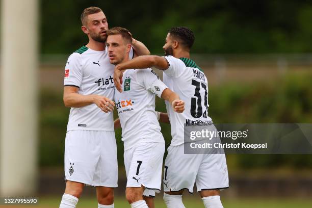 Patrick Herrmann of Moenchengladbach celebrates the second goal with Michael Lieder and Keanan Bennetts during the pre-season Bundesliga match...